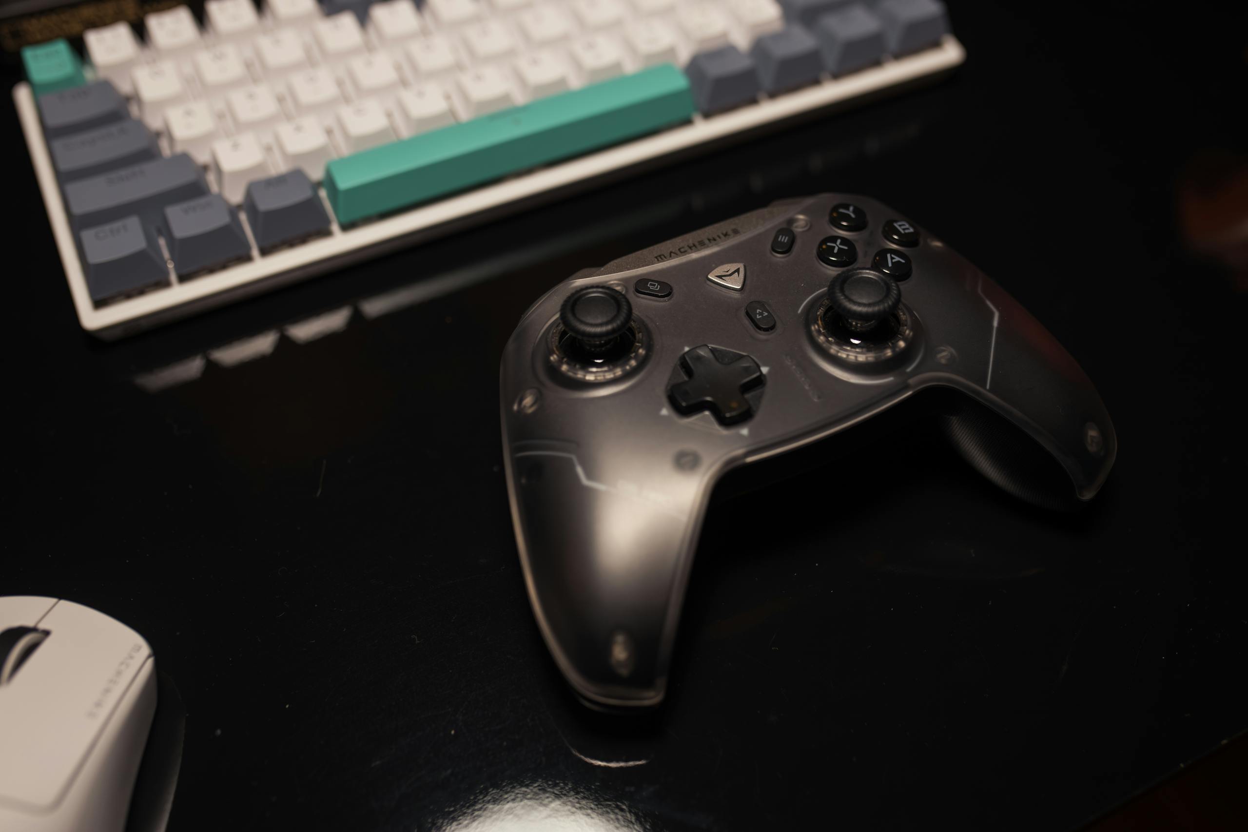 Close-up of a gaming controller on a desk with a keyboard and mouse, perfect for gamers.